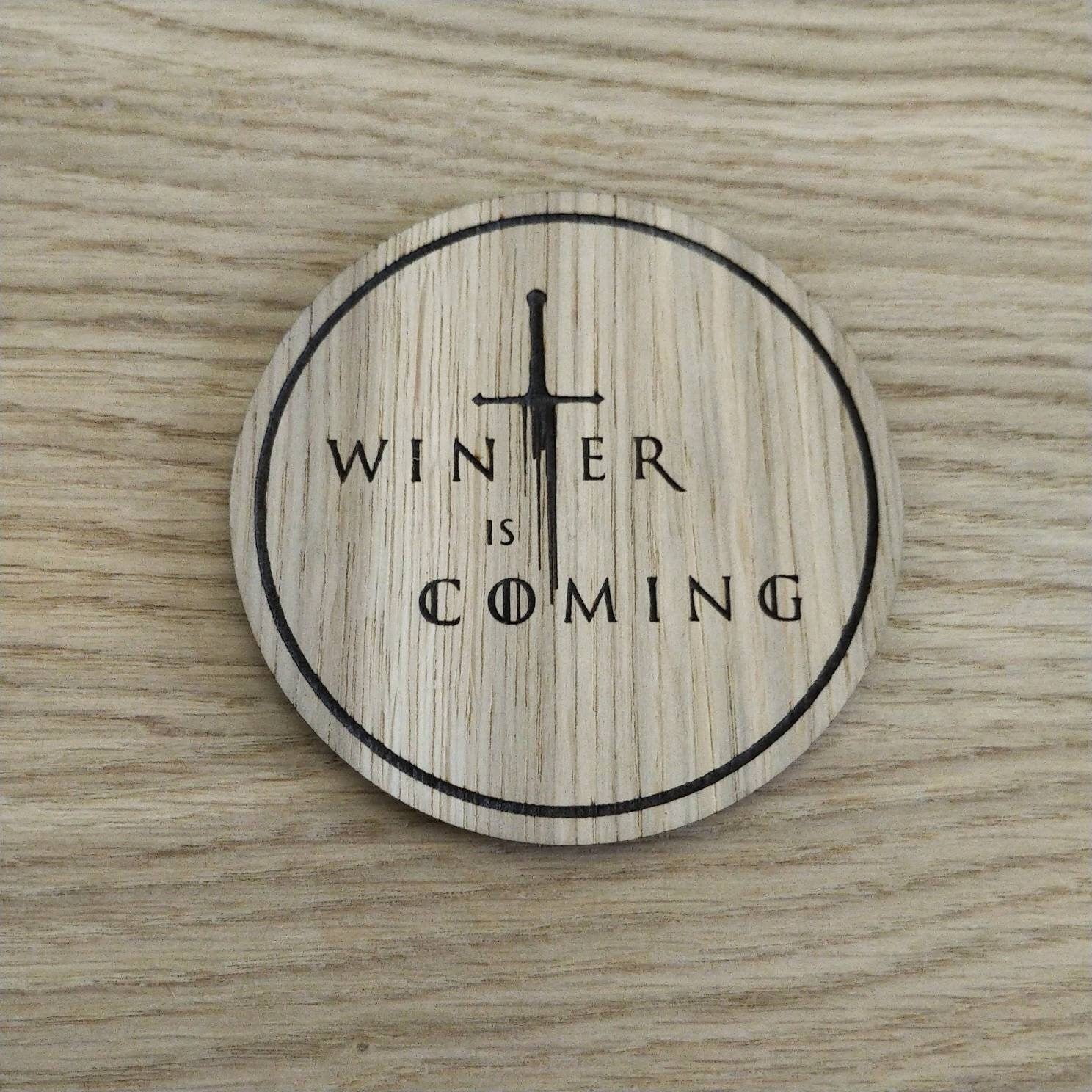Laser cut wooden coaster. winter sword quote