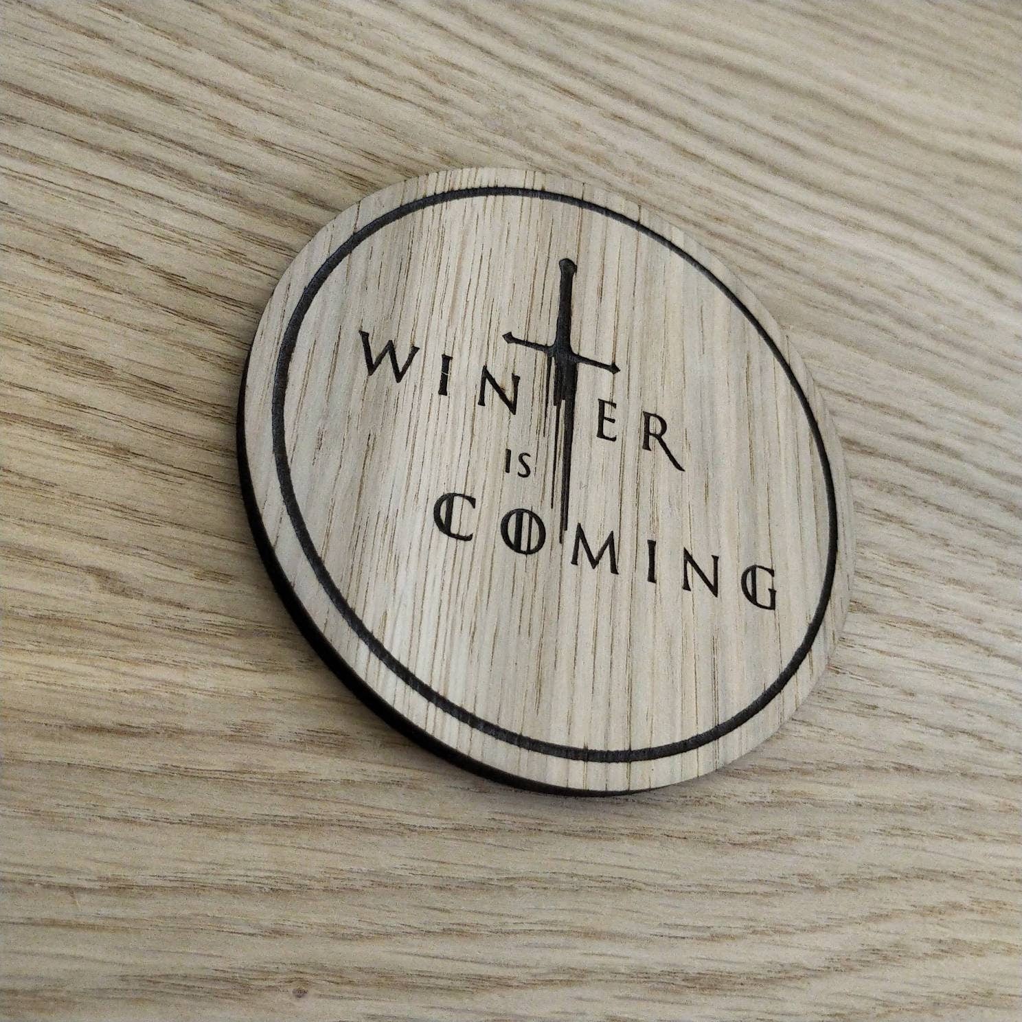 Laser cut wooden coaster. winter sword quote
