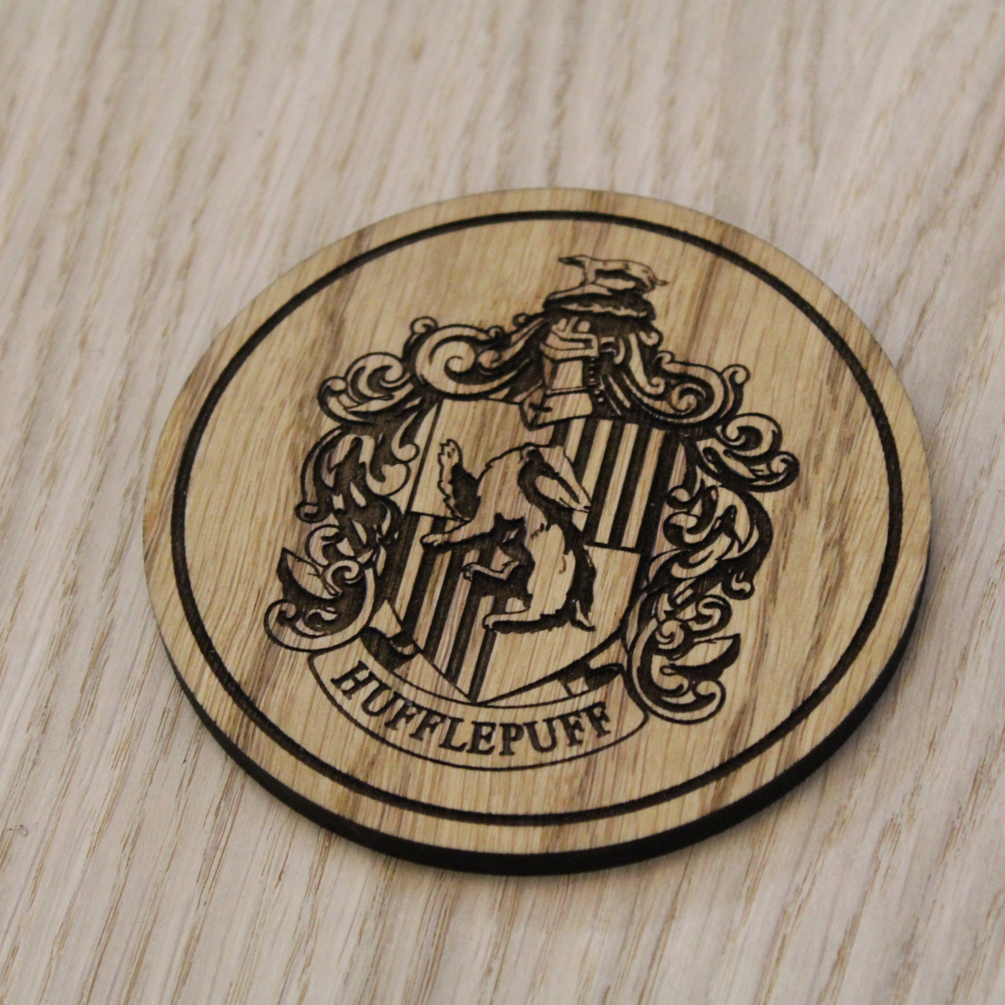 Laser cut wooden coaster. Huffle puff