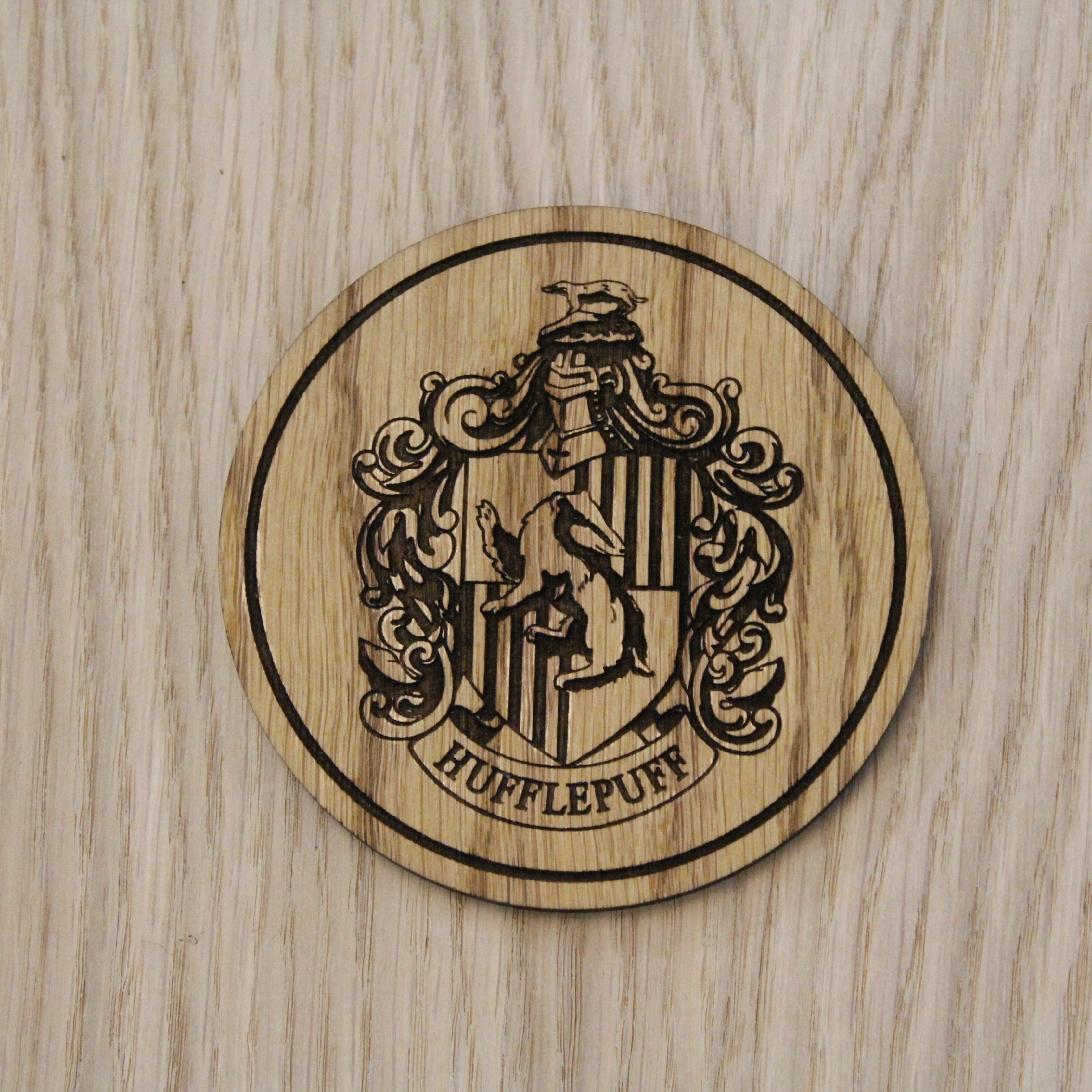 Laser cut wooden coaster. Huffle puff