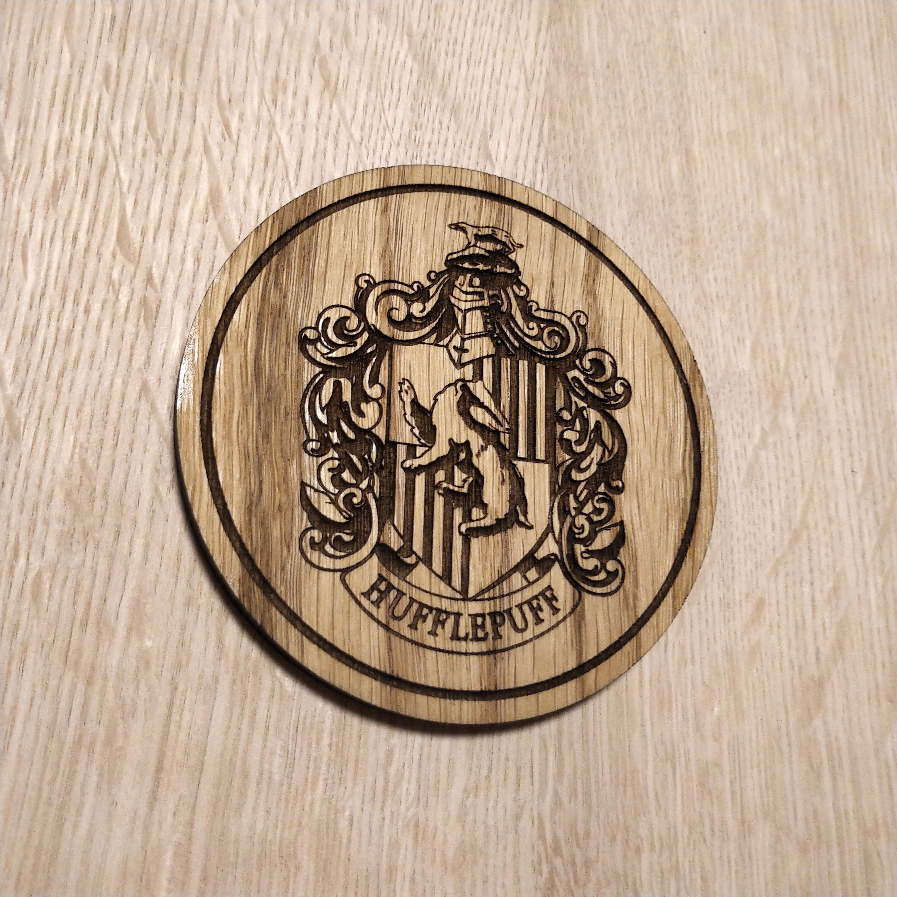 Laser cut wooden coaster. Huffle puff