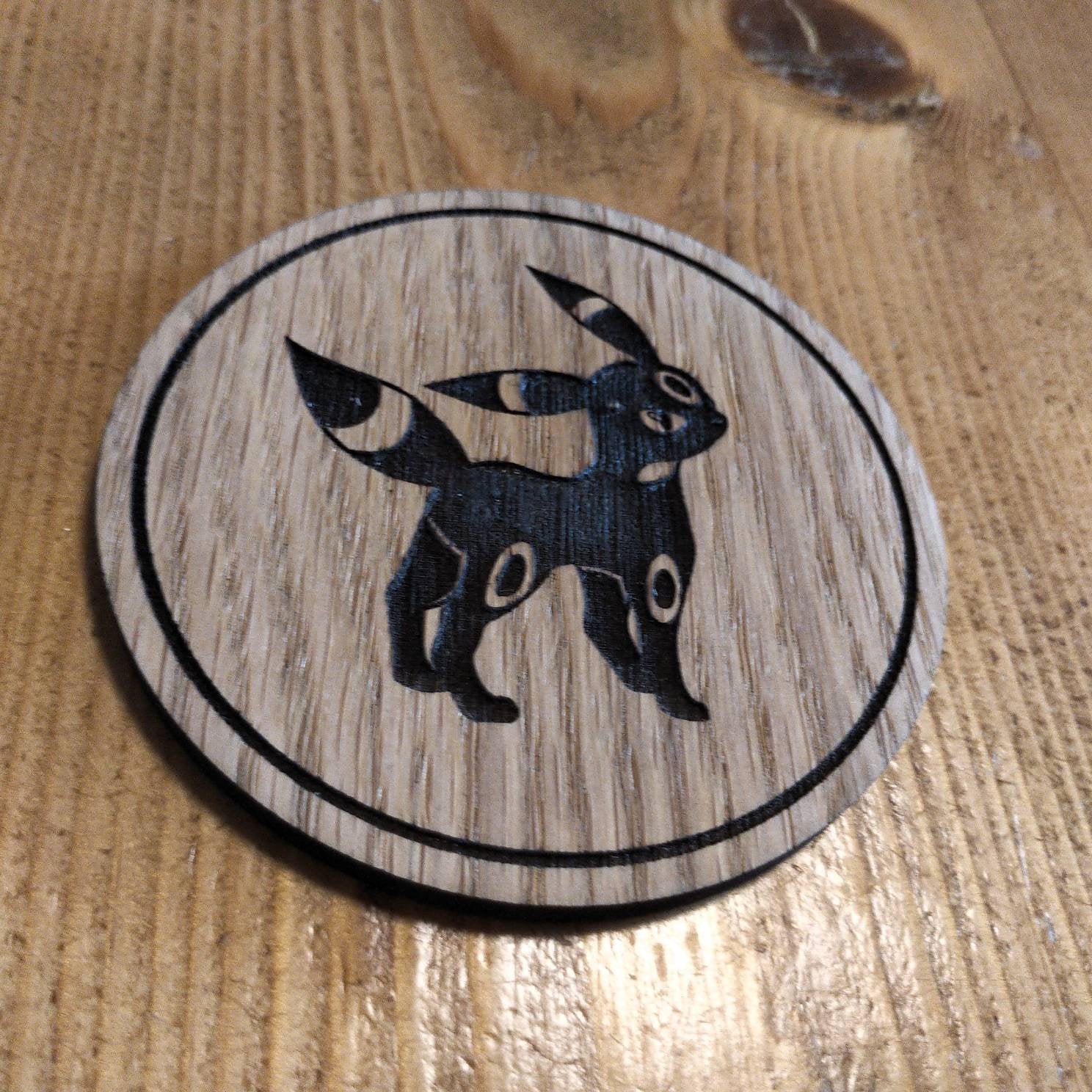 Laser cut wooden coaster. Eevee Obsidian
