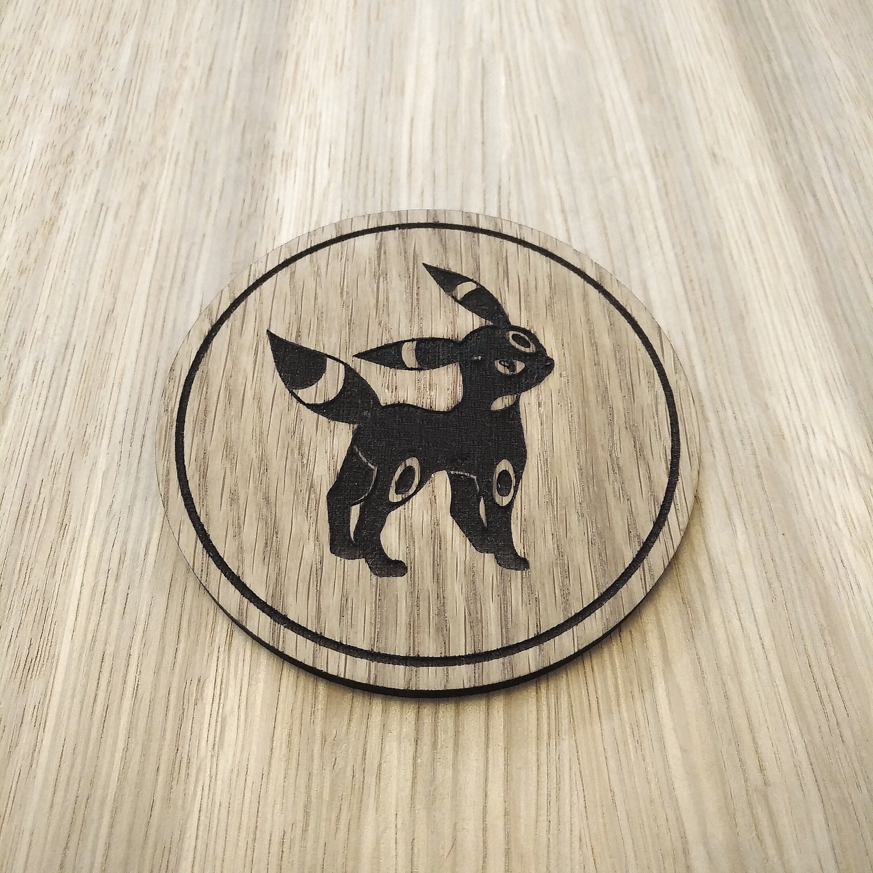 Laser cut wooden coaster. Eevee Obsidian