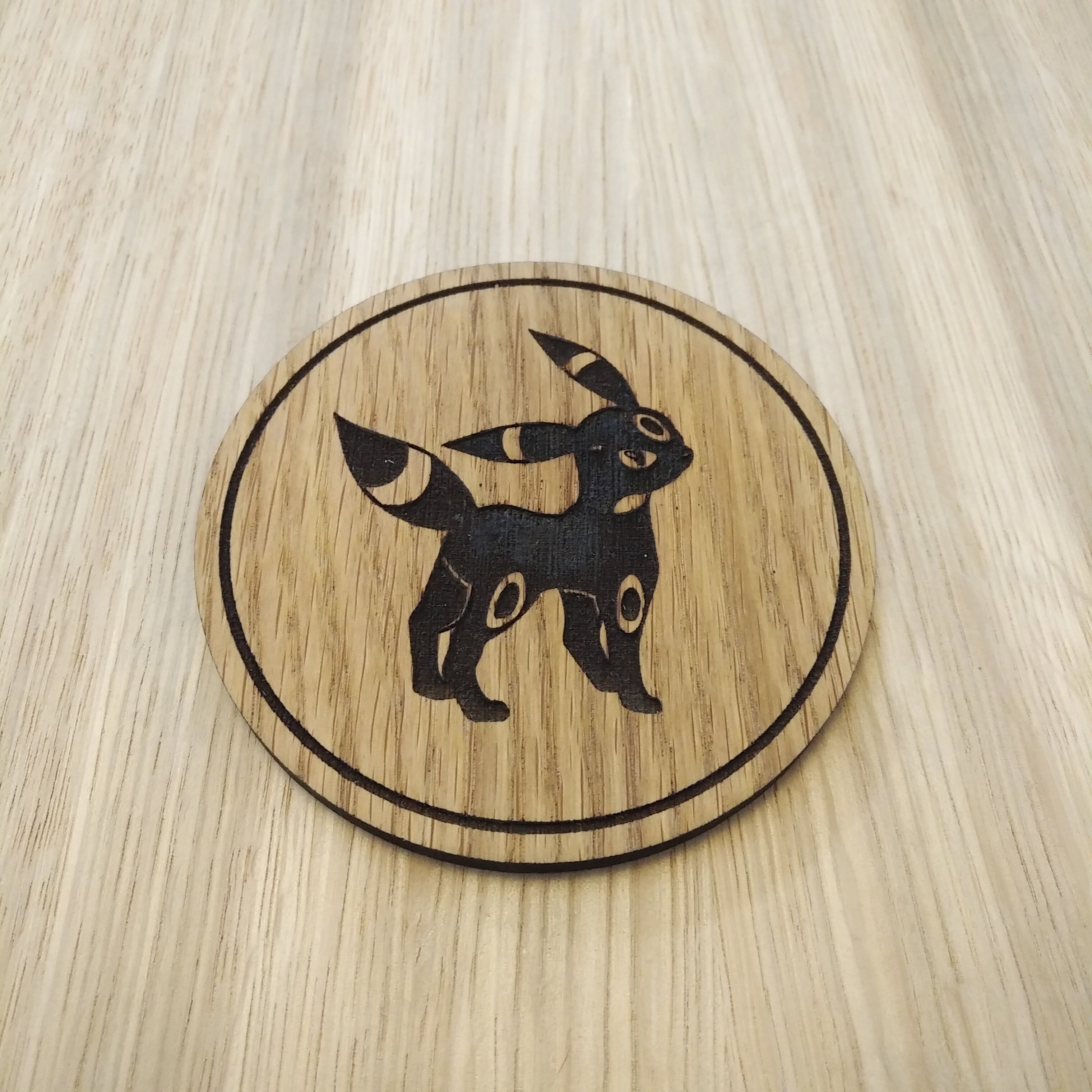 Laser cut wooden coaster. Eevee Obsidian